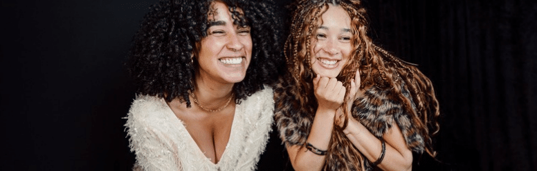Two guests smiling together during an interactive Proptography Co holiday photo experience.
